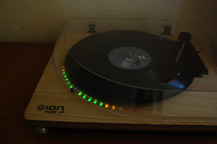 Turntable with lit LEDs along the diameter of the record it's playing